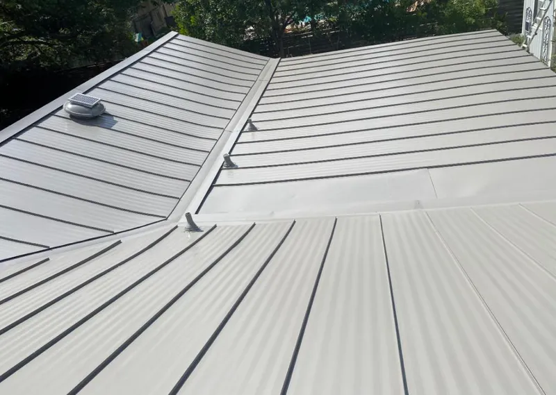 Solar attic fan installed on a metal roof for Roof Ventilation in Olmsted Falls